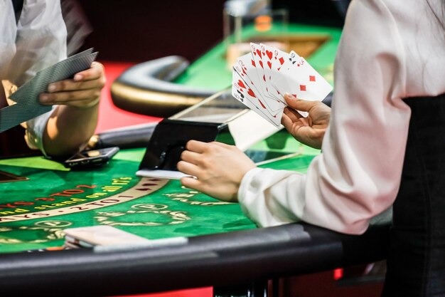Overhead view of Sic Bo table with three certified dice and dealer hands in frame